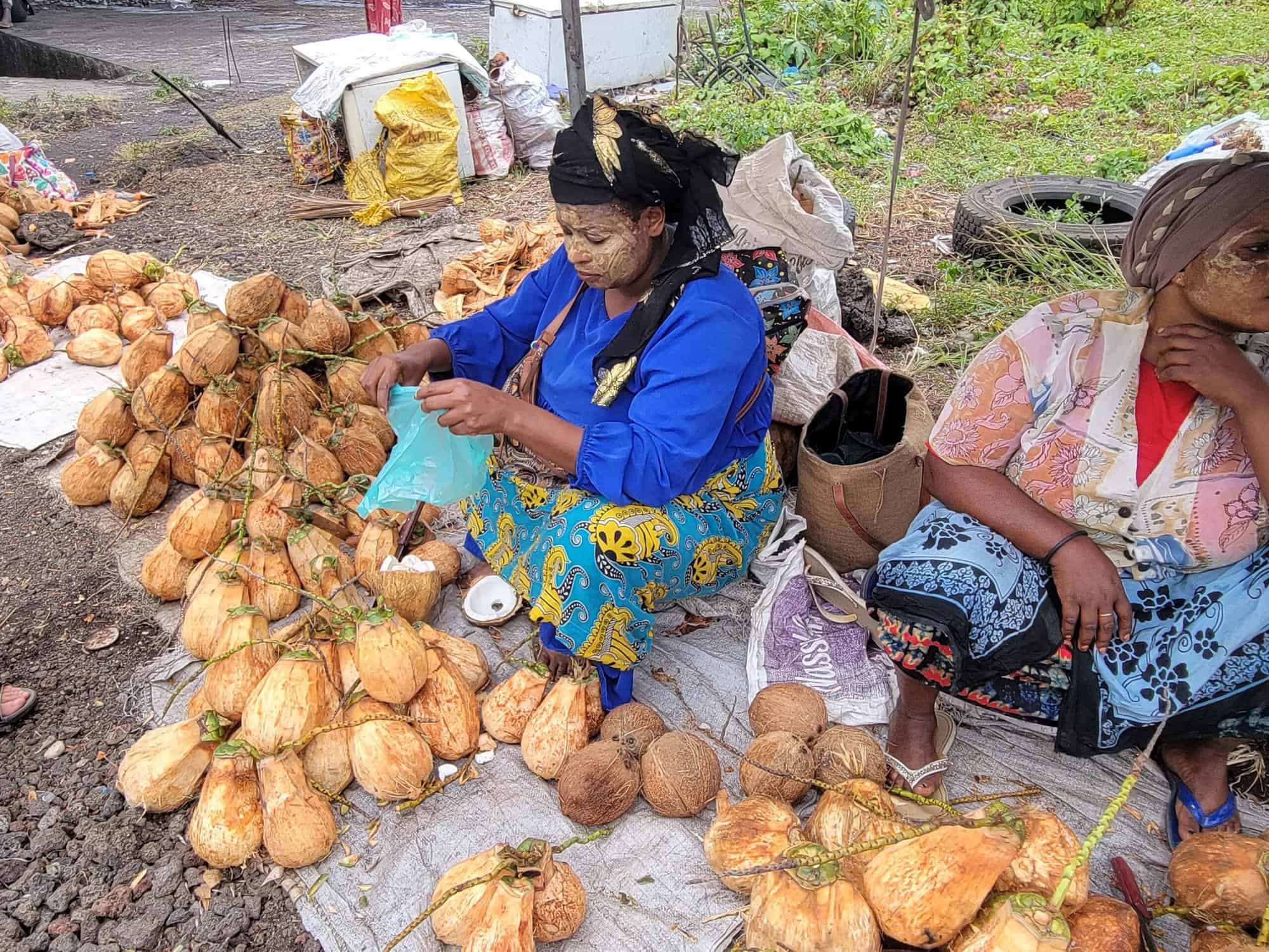 Comoros - local ladies selling fresh coconuts on the streets